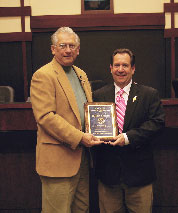 Tim Seeden is presented an award by the mayor